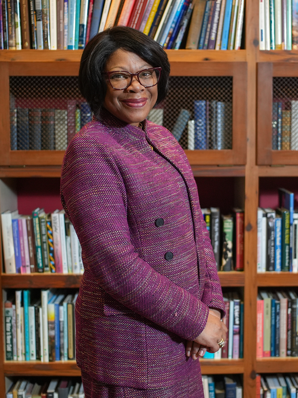 Anita Brown-Graham stands in front of a large bookcase.