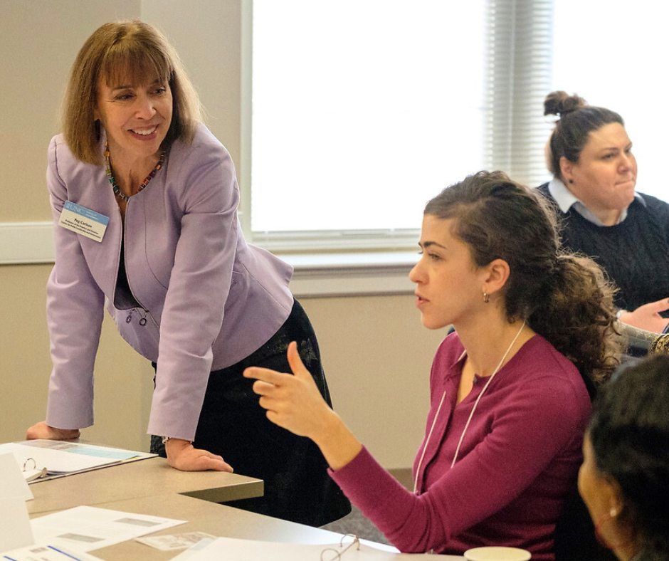 Peg Carlson speaks with participants in a facilitations skills course at the School of Government