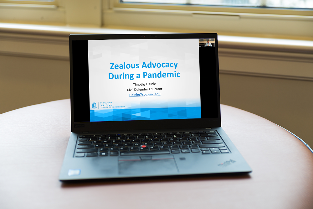 A black laptop open to a Powerpoint presenttion titled "Zealous Advocacy During a Pandemic."