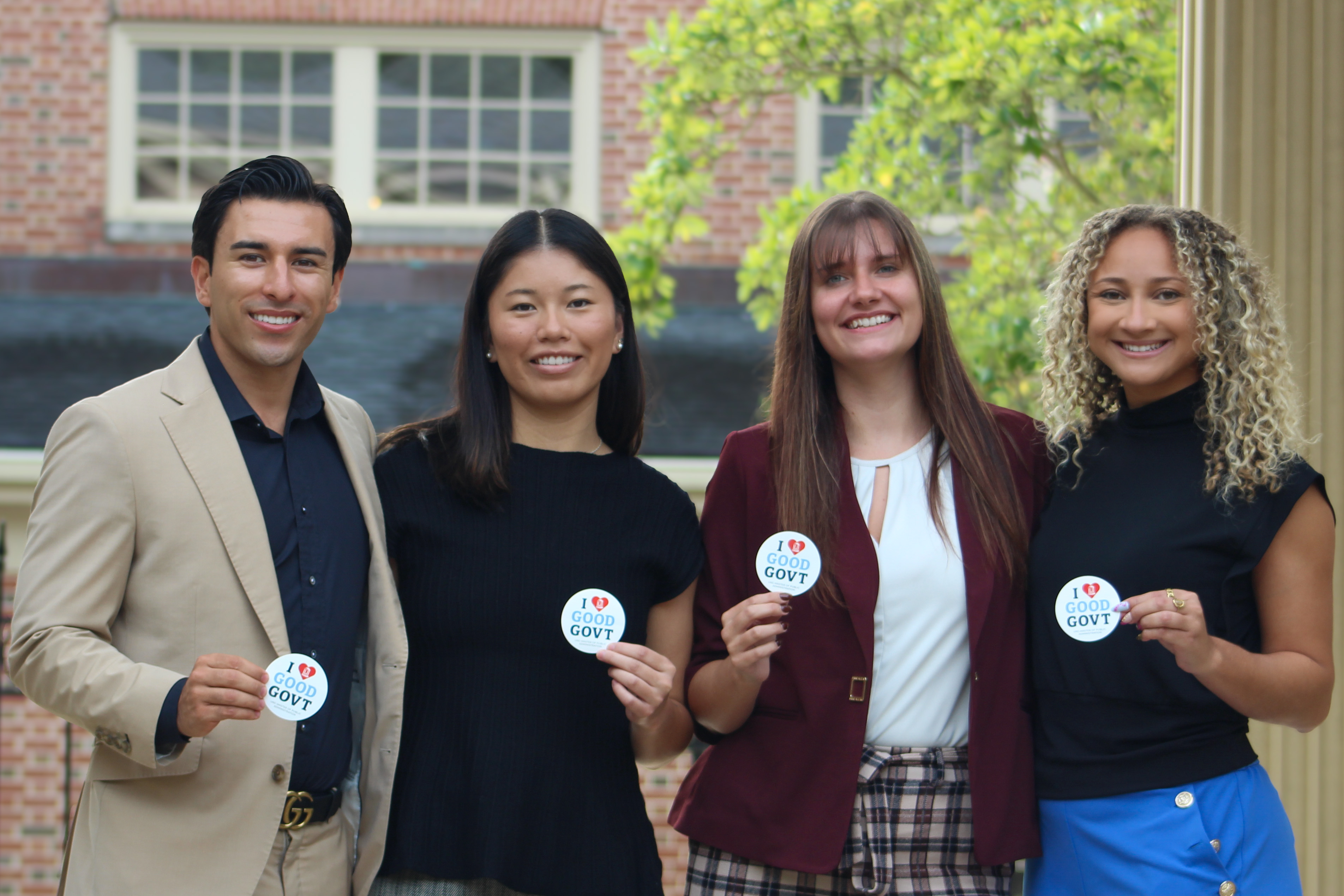 Students holding stickers that say "I heart good goverment."
