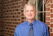 Headshot of David Ammons in front of a brick wall