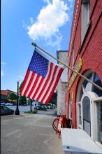 An American flag flies outside a red brick building in downtown Kinston, North Carolina