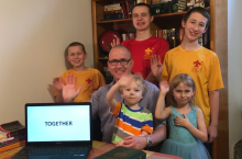 Faculty member Trey Allen waves at the camera with his children